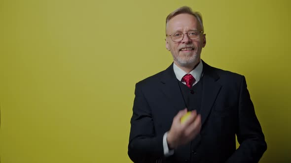 Portrait of happy mature man with apple