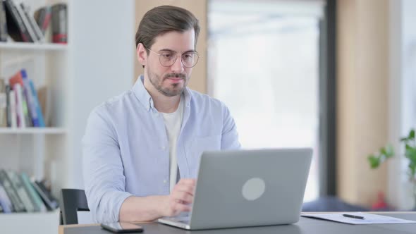Man in Glasses with Laptop Having Wrist Pain