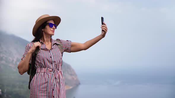 Elegant Female Photographing Use Smartphone Mountain Peak Over Sea Smiling Enjoying Travel Vacation