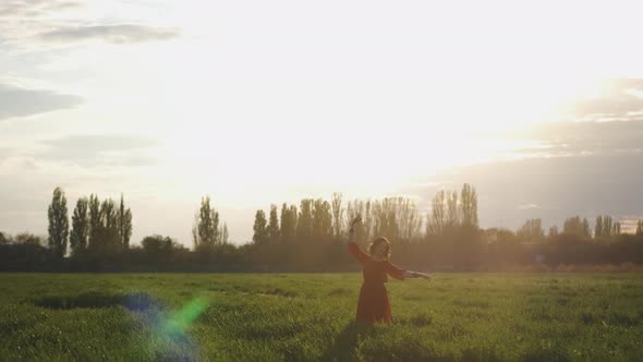 Beautiful Spanish Brunette Woman in Red Dress Dancing at Sunset in Wheat Field Slow Motion Shot