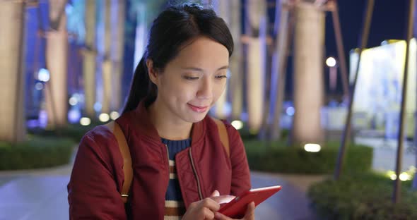 Woman Check on Smart Phone at Outdoor