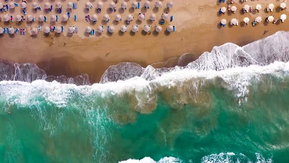 Aerial View of the Sea Sandy Beach Sun Umbrellas and Sunbeds Unrecognizable People