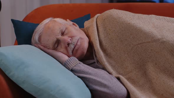 Tired One Senior Old Man Lying Down in Bed Taking a Rest at Home Napping Falling Asleep on Sofa