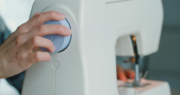 Phased Sewing of Medical Masks From Blue Fabric on a Sewing Machine. Close Up Industrial Sewing