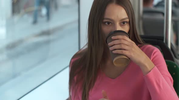 Young Stylish Woman Dressed Brightly Enjoying Trip at the Public Transport, Sitting in the Modern