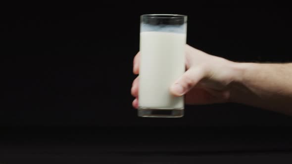 Putting down a filled glass of milk