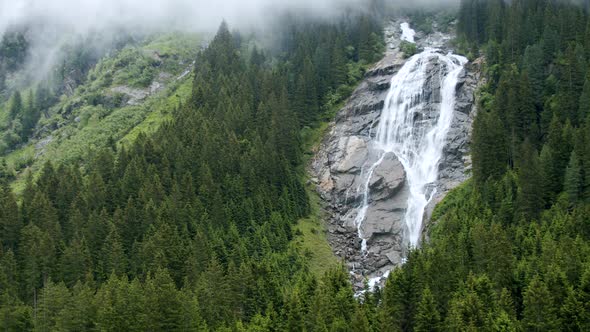 Grawa Waterfall in Rainy Pine Tree Forest in Stubai Austria