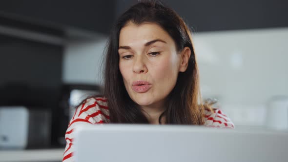 Woman Having Online Meeting Via Laptop at Home