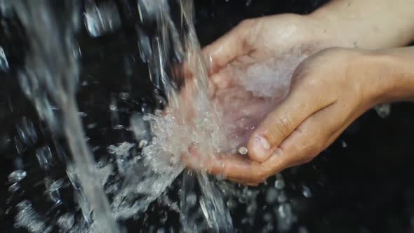 Water Pours in Man's Hands