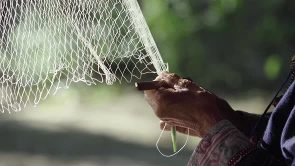 Hands woman weaving fishing nets
