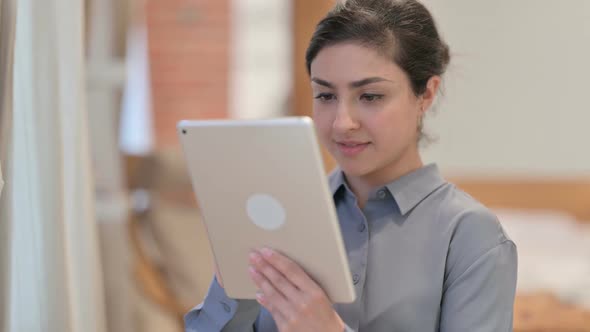 Portrait of Young Indian Woman using Tablet