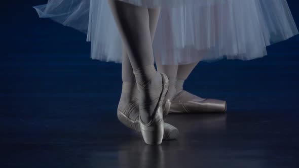 Ballerina's Legs Dancing in Golden Pointe Shoes. Close Up, Slow Motion.