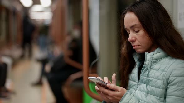 Portrait of a Brunette with Long Hair on the Electric Train