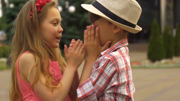 Children Cover Their Mouthes with Hands