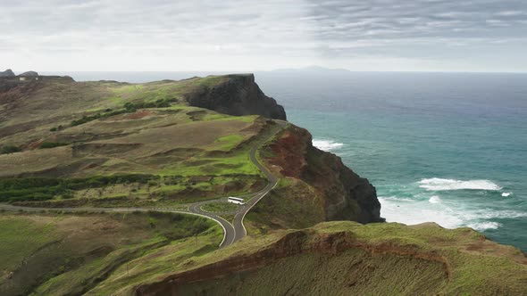 Aerial View of Picturesque Coastal Road with a Bus Driving Along