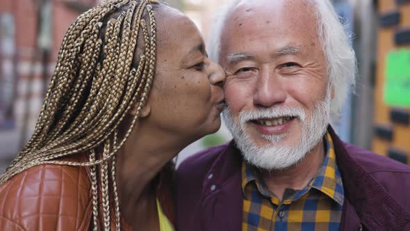 Happy senior couple having tender moments in city - Elderly people and love relationship concept