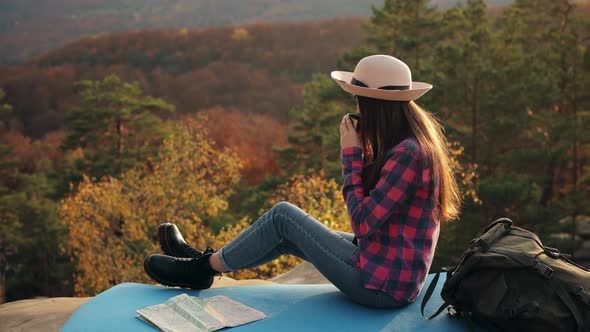 A Young Woman is Drinking Hot Tea