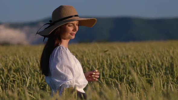 Young Girl Walking in Slow Motion Through a Wheat Field