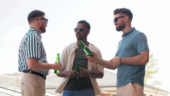 Happy Male Friends Drinking Beer at Rooftop Party