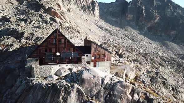 Drone aerial view of the wooden cabine of Orny in the swiss alps, rocky mountains