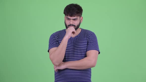 Stressed Young Overweight Bearded Indian Man Thinking