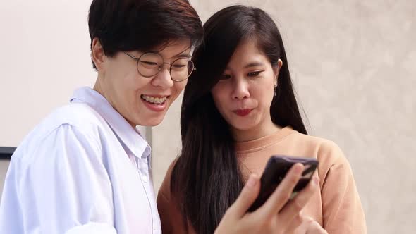 Asian LGBT couples work together at home. Small business entrepreneurs.