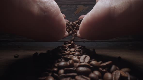 Human Hand touching Roasting brown Coffee Beans with steam. tracking shot, close up