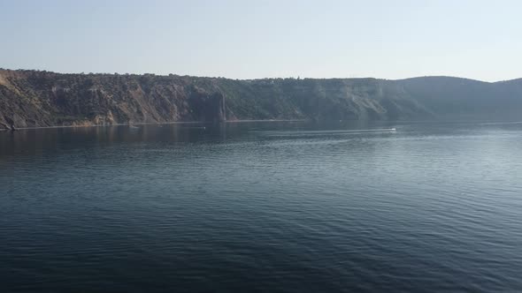 Aerial View From Above on Calm Azure Sea and Volcanic Rocky Shores