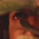 Close up shot of blue eyed man peaking through plants to take pictures - VideoHive Item for Sale