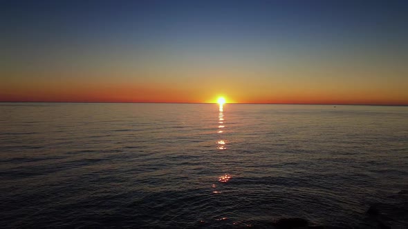 Flying Over the Sea in Sunrise