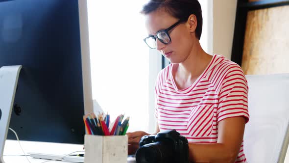 Female executive working over computer