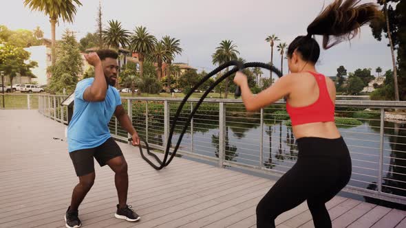 Woman working out with a trainer in the park