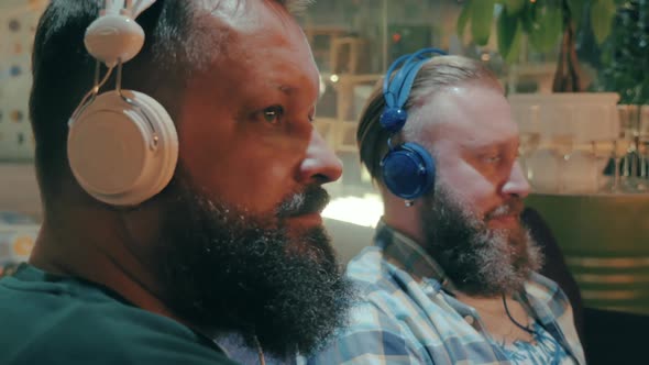 Bearded Men in Headphones Enjoying Music