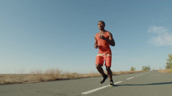 AfricanAmerican Man Runs Along the Road