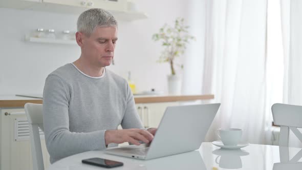 Senior Old Man Using Laptop at Home 