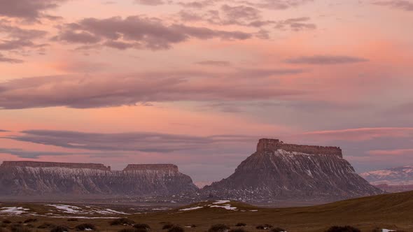 Time lapse of colorful sunrise over Factory Butte in the Utah desert