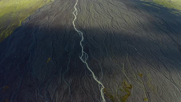 Drone Over Sunlit Landscape With Dry Riverbed Of Braided River