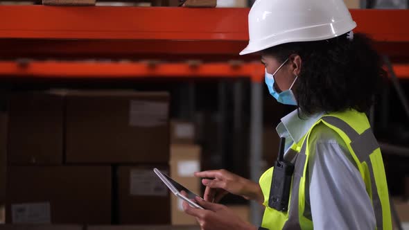 Warehouse Supervisor in Face Mask During Inventory