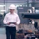 Shot of Professional Factory Worker Wearing Hard Hat Holds Tablet Computer Walking Thorugh Modern - VideoHive Item for Sale