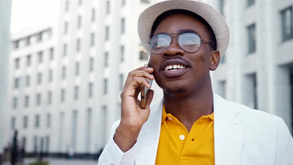 Joyful African American businessman in white suit