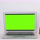 Laptop with mockup green screen on a white table with house plant and tea in home office. Stop motio - VideoHive Item for Sale