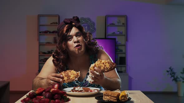 Man Dressed in Woman's Dress and Makeup on Face Eats a Huge Sandwich