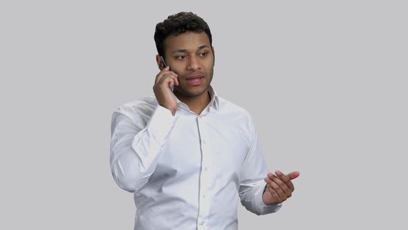 Young Hindu Guy Talking with Transparent Mockup Mobile Phone