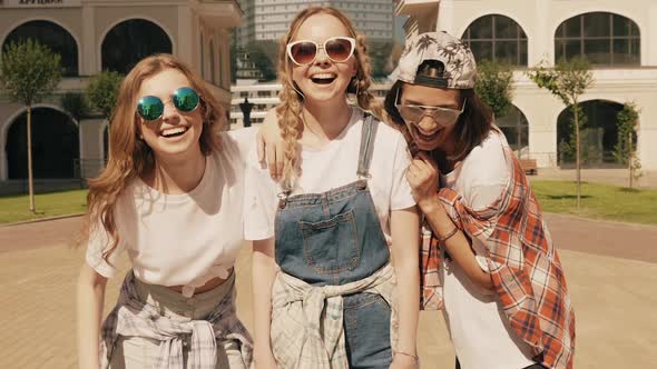 Carefree women posing on the street background