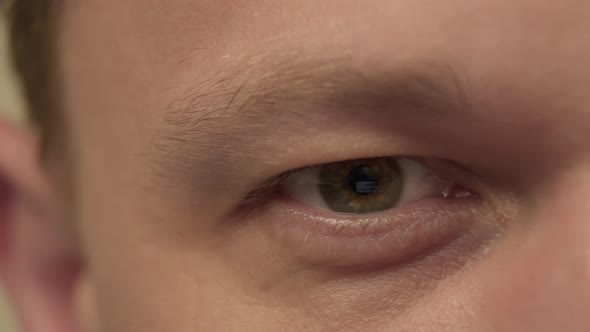 Eyes of a man, reflection of the monitor, camera movement, close-up