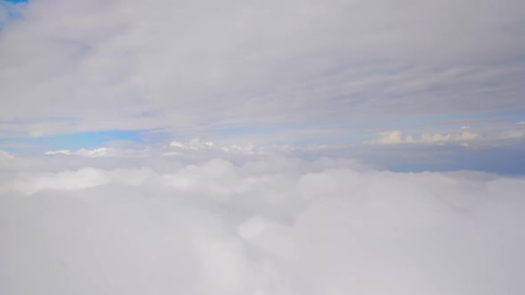 Layers of thick clouds viewed from airplane, gaining altitude, travelling by air