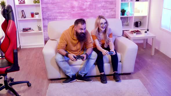 Cheerful Couple Making Fist Bump After Wining at Online Games