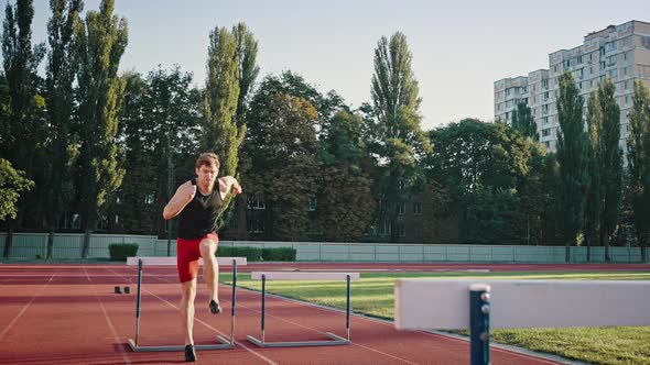 Athlete Jumps Over Obstacles