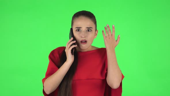 Portrait of Pretty Young Woman Is Upset Speaking on the Phone, Proving Something. Green Screen