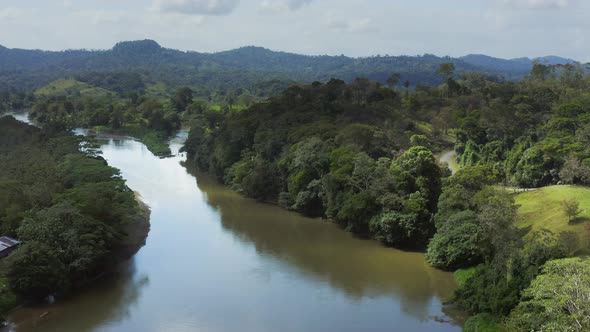 Aerial Drone View of Rainforest River and Mountains Scenery in Costa Rica at Boca Tapada, San Carlos